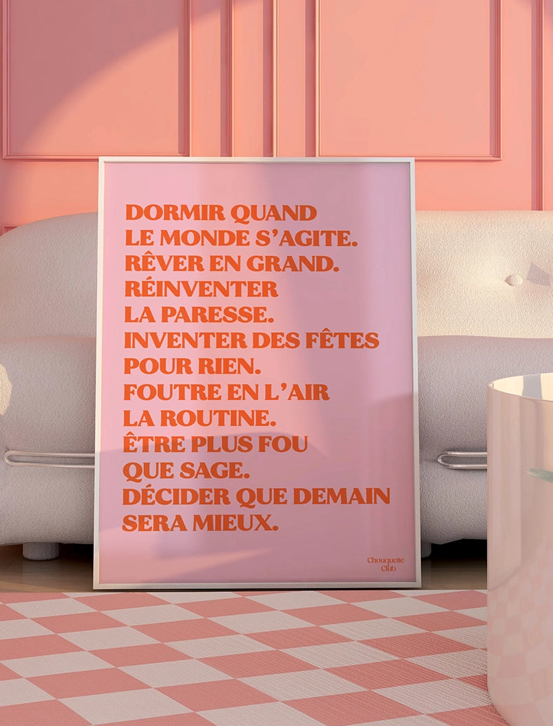 Mantra rose et orange encadré de la marque Chouquette Club posé au sol dans un salon.