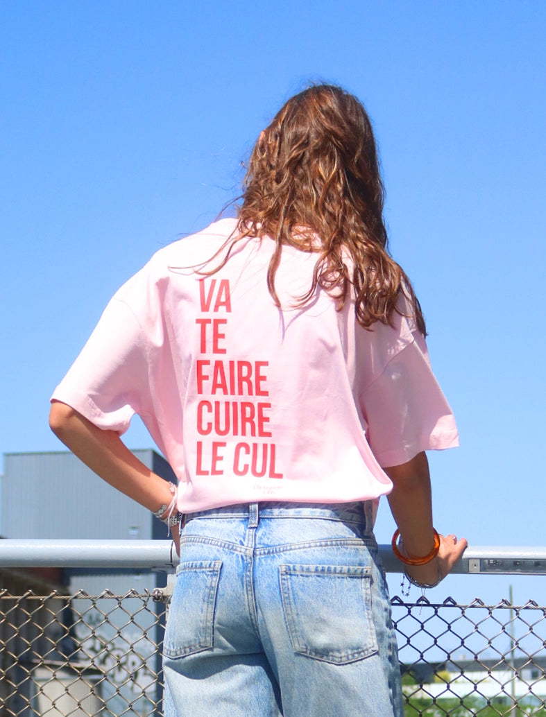 Tee-shirt femme "Va te faire cuire le cul" rose porté par une jeune femme brune
